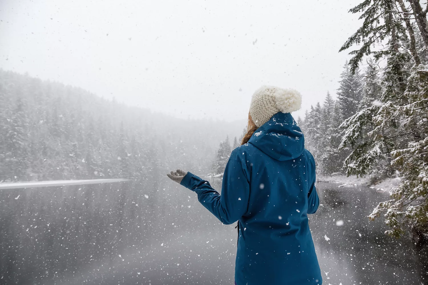 Woman enjoying the beautiful Canadian Winter Landscape during a snowy day. Taken near Squamish and Whistler, North of Vancouver, BC, Canada.
